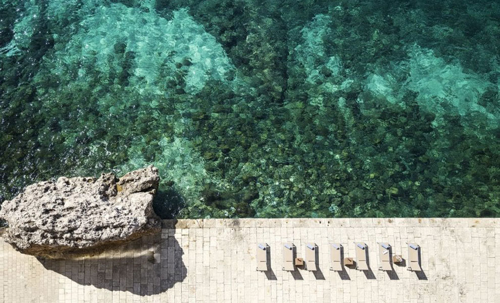 The Excelsior's swimming pool merges with the sea.