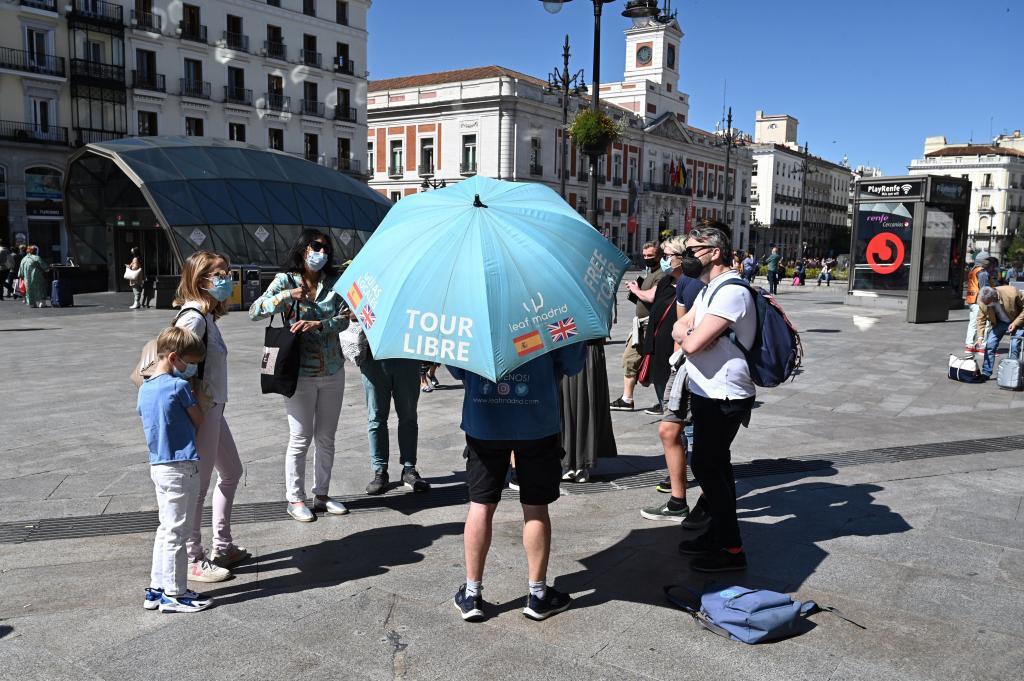 Several tourists listen to the explanations of a gu